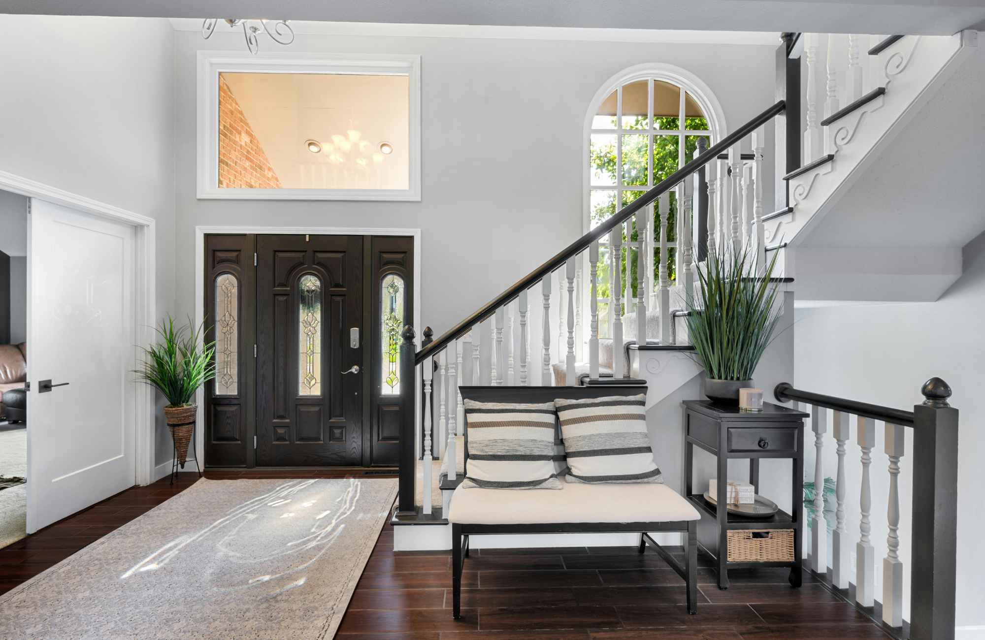 professional-home-organizer-clearwater-fl-daily-organization-habits-home-entryway-high-ceiling-dark-wood-floor-bench-by-stairs-calm