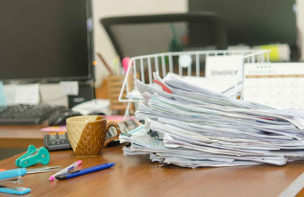 you-organized-by-barb-tampa-bay-fl-why-typical-organizing-systems-don't-work-pile-of-papers-on-desk-with-clutter-simplify-whole-home-organization